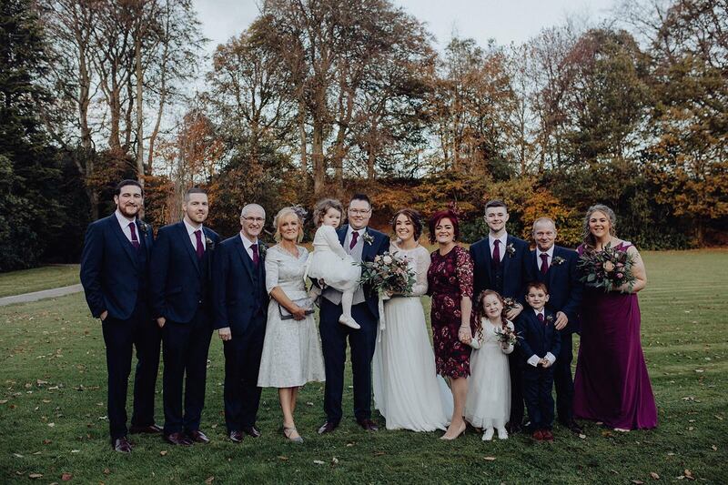 Leancha and Christopher with family on their wedding day in 2018.