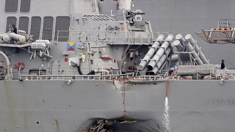 The damaged port aft hull of the USS John S. McCain is visible while docked at Singapore&#39;s Changi naval base in Singapore 