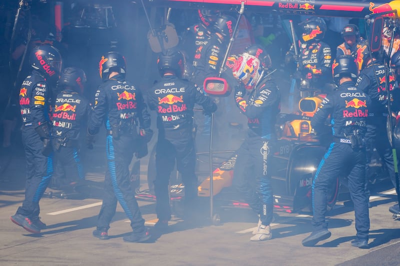 Mechanics worked to extinguish a fire in Max Verstappen’s car (Scott Barbour/Pool/AP)
