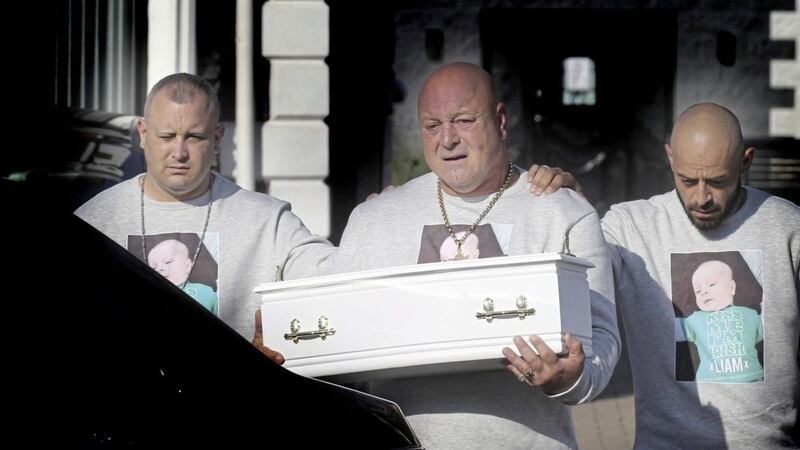 Liam O'Keefe (snr) carries his baby son, Liam's coffin during the two-month-old's funeral in north Belfast today. Picture by Hugh Russell