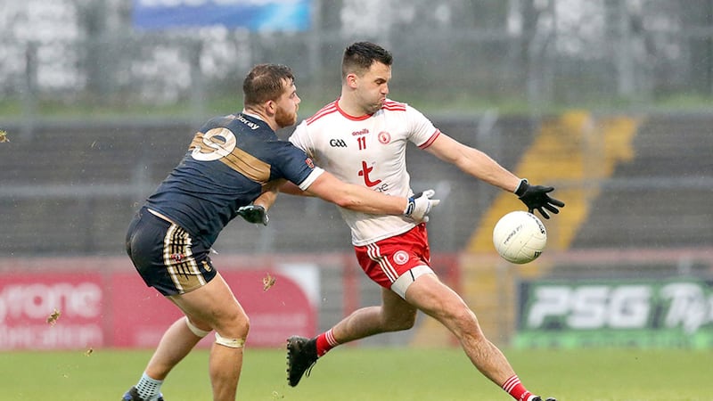 Tyrone's Kyle Coney with Rory Mullen from UU during the Dr McKenna Cup tie at Healy Park