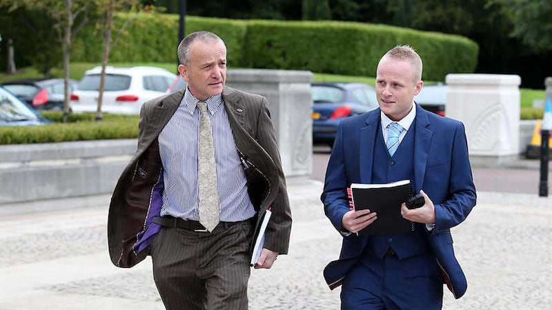 Jamie Bryson (right) arrives at Stormont today