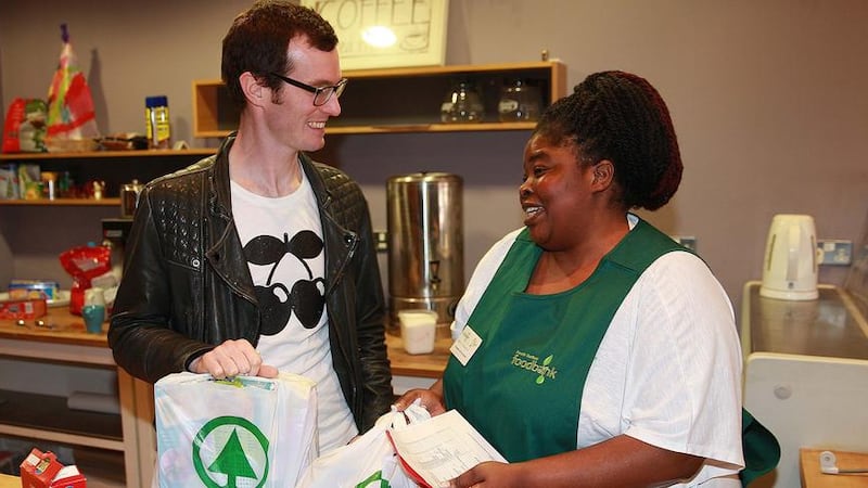 Manager Bruce Gardiner-Crehan and volunteer Beauty Chiyangwa at the South Belfast Food Bank in the Ormeau Road&#39;s Mornington Community Centre Picture by Bill Smyth 
