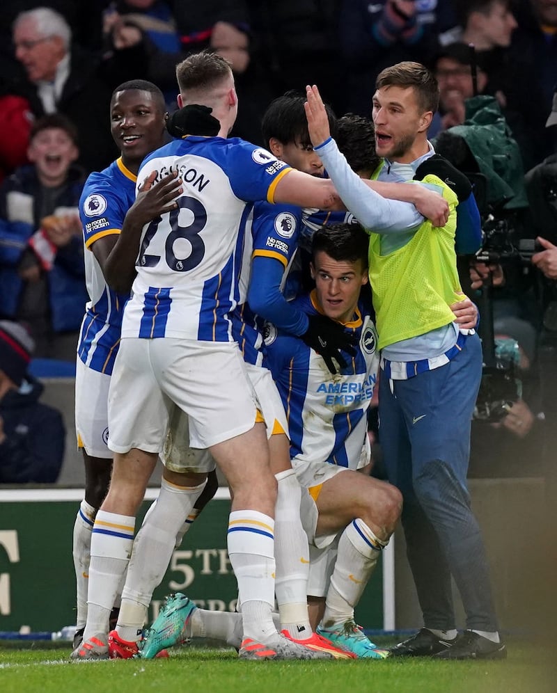 Solly March, second right, celebrates with team-mates including Evan Ferguson, second left, and Kaoru Mitoma, centre, after scoring against Liverpool last season