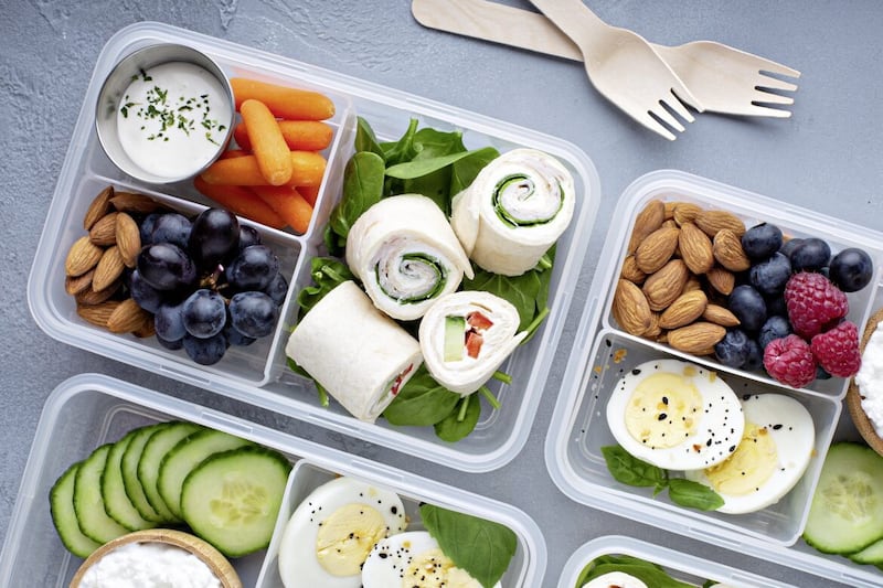 Healthy lunch or snack to go with tortilla wraps, eggs, cottage cheese, fruits and vegetables 