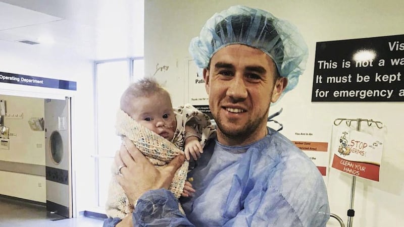 Leading Antrim GAA player Conor Murray with his four-month-old daughter, Camille, who underwent life-saving heart surgery in Dublin last Friday. 