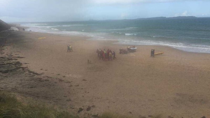 A man being stretchered off Whiterocks beach in Portrush, Co Antrim, after he fell 12ft onto rocks from a cliff path 