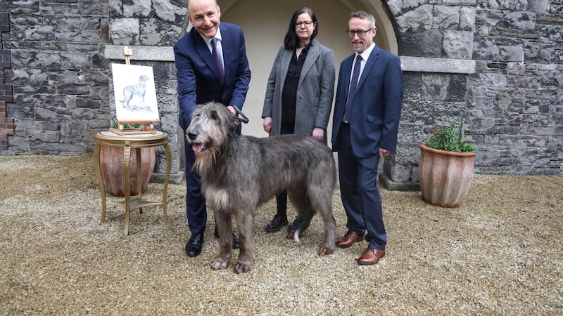 Micheál Martin with illustrator Denise Nestor, document designer Wil Byrne of design firm AG2, and Irish wolfhound Boánn.