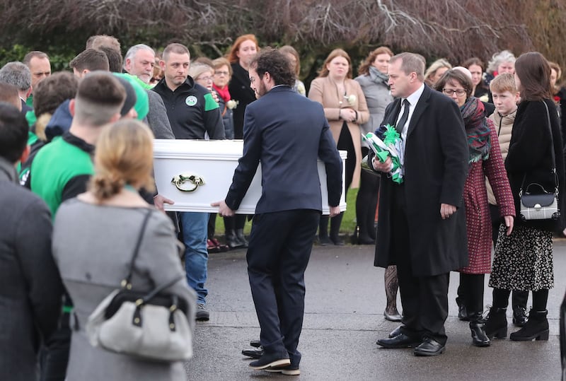 Andrew McGinley (right) watches as a coffin of one of his three children is carried into the Church of the Holy Family in Rathcoole, Dublin during the funeral of siblings Conor, Darragh and Carla McGinley at the Church of the Holy Family in Rathcoole, Dublin. Picture by Niall Carson/PA Wire&nbsp;