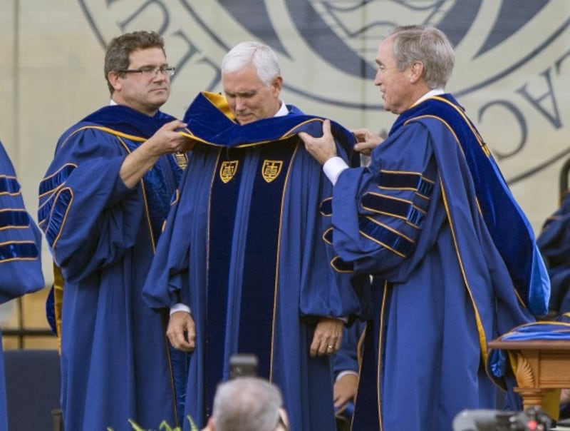 Vice President Mike Pence, centre, receives an honorary degree