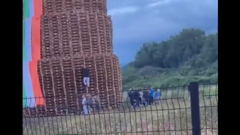 Footage taken in Newtownards on July 11 shows people rushing to the aid of a man after he fell from a bonfire in the Portaferry Road area.