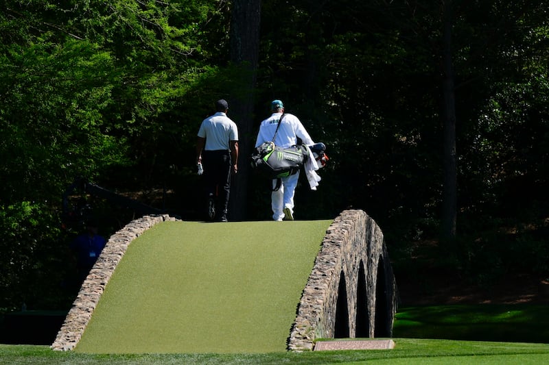 Tiger Woods walks over the Ben Hogan Bridge on the 12th hole during the third round of the Masters (Matt Slocum/AP)