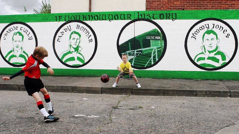Jordan O'Donnell and Conor Morgan play at the mural in honour of Belfast Celtic unveiled at the junction of St James'&shy; Road and St Catherine'&shy;s Road to mark the 60th anniversary of the club's demise.
