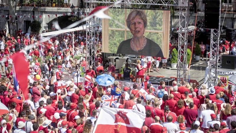 British Prime Minister, Theresa May, is seen on a video during the National Day meeting at the British territory of Gibraltar on Sunday. Gibraltar, a rocky outcrop at the tip of the Iberian Peninsula with 32,000 residents, has strong economic connections with surrounding Spanish regions. In last year's vote, 96 percent of Gibraltarians voted for Britain to remain in the EU. (AP Photo/Marcos Moreno).