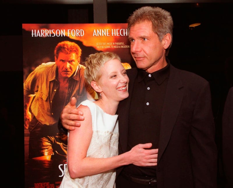 Anne Heche and Harrison Ford embrace at the premiere of their film, Six Days, Seven Nights in 1998 