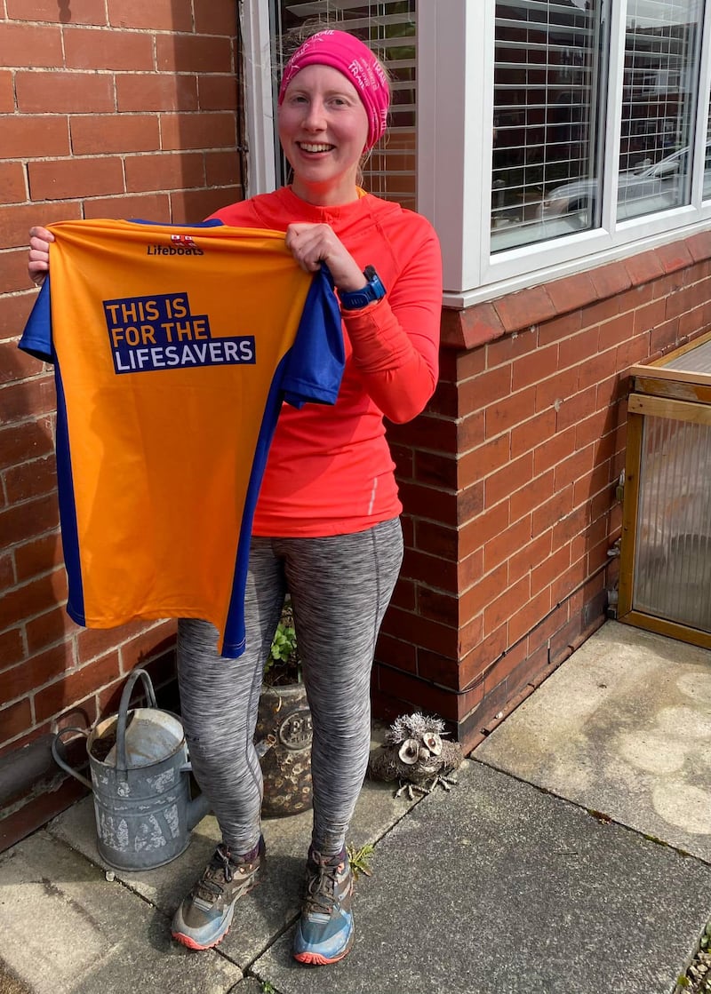 Ms Houghton shows off a t-shirt made ahead of a 10k race to raise money for the RNLI.