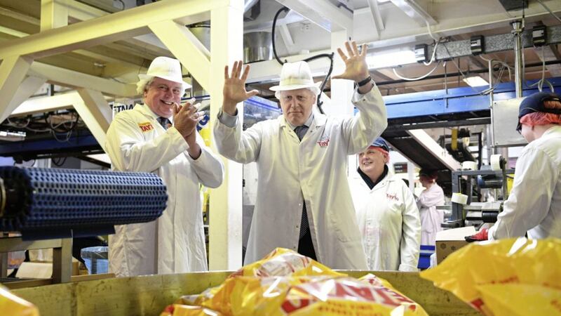 CHEESE AND UNION: Prime Minister Boris Johnson at the Tayto Castle crisp factory in Tandragee, Co Armagh           Picture: Stefan Rousseau/PA 