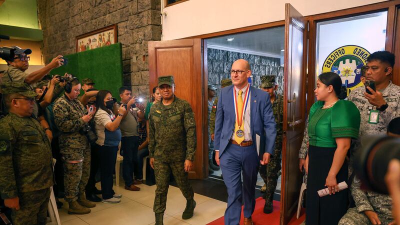 Philippines’ military Chief Gen Romeo Brawner Jr, and US Embassy Charge d’ Affaires, Robert Ewing, arrive during the opening ceremonies (AP)
