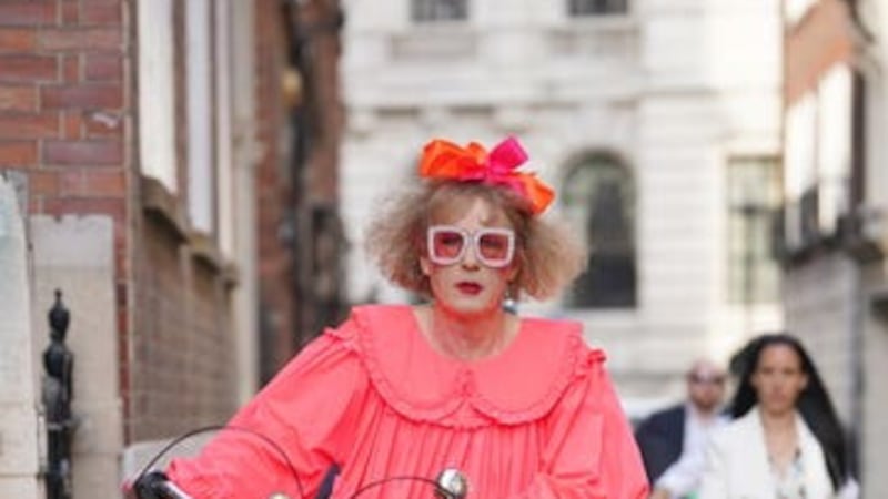 Sir Grayson Perry dons neon, tiered baby-doll dress for Spectator summer party (Lucy North/PA)