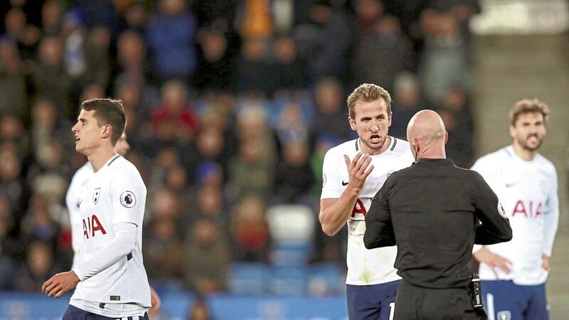 Tottenham&#39;s Harry Kane (centre) appeals the decision of match referee Anthony Taylor as he gives team-mate Erik Lamela (left) a yellow card during the 2-1 defeat to Leicester 