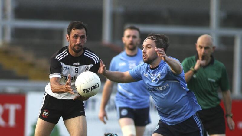 Kilcoo's Aiden Branagan gets the ball away as Mayobridge's Corey Quinn closes in during the Down SFC clash at Pairc Esler, Newry last night, Friday August 14 2020. Picture by Hugh Russell&nbsp;