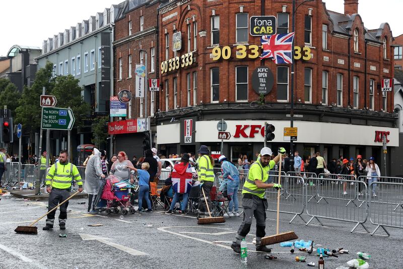 Council cleansing staff clean up following the Twelfth parade through Belfast.