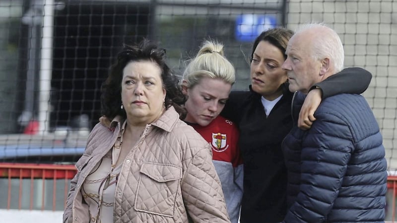 Damian Casey&#39;s devastated parents Sean and Susan and his sisters Louise and Catherine attend a vigil at Eoghan Ruadh GAA club. Picture By Hugh Russell. 