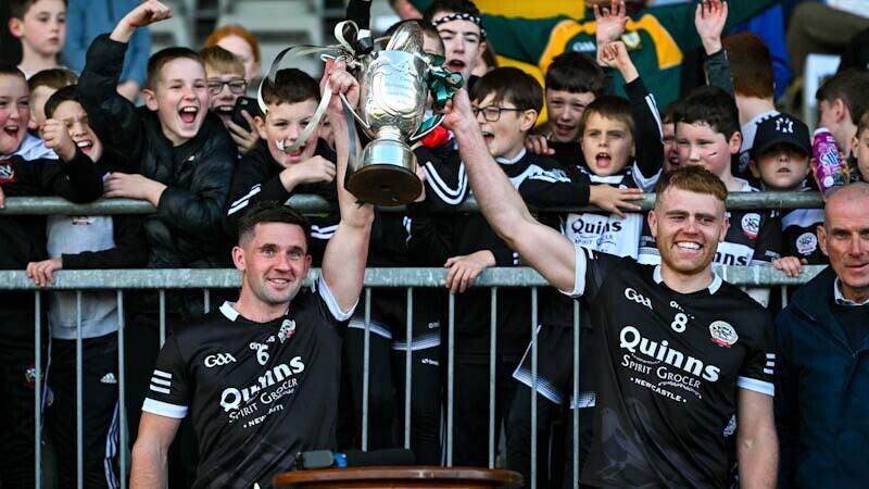 Darryl Branagan and Aaron Morgan hoist aloft the Frank O'Hare Cup after Sunday's Down final victory over Burren. Picture by Sportsfile