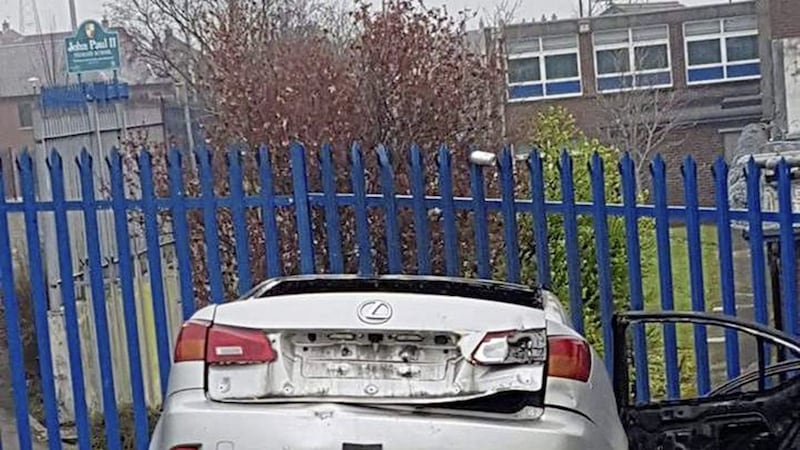 Car thieves caused damage to fencing at John Paul II Primary School before abandoning the stolen vehicle. Picture from Belfast IRSP/Facebook 