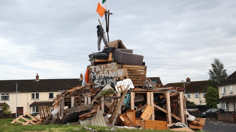 An effigy above a poster with the name of Taylor McGrann, the Sinn Fein Councillor for Antrim & Newtownabbey Borough, on the bonfire at Carnreagh Bend, Rathcoole, Newtownabbey