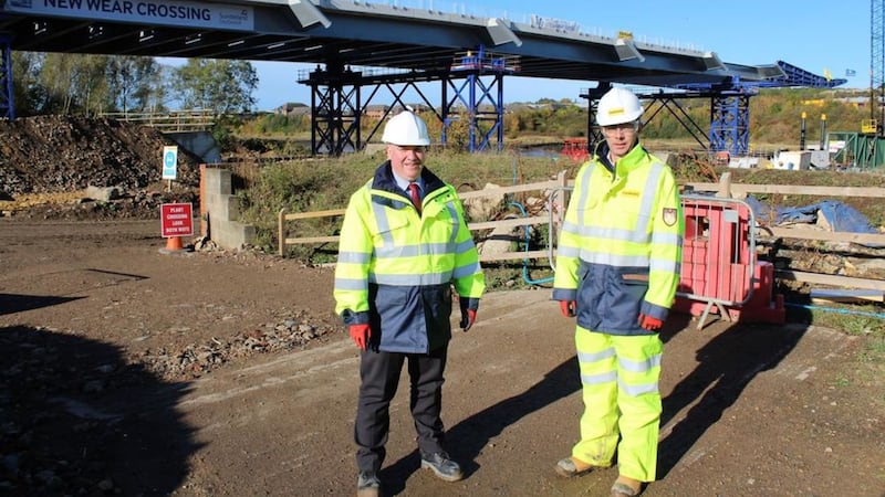 Moore Concrete&#39;s Richard Whiteside and Farrans&#39; Stephen McCaffrey with the new bridge over the River Wear spanning out behind them 