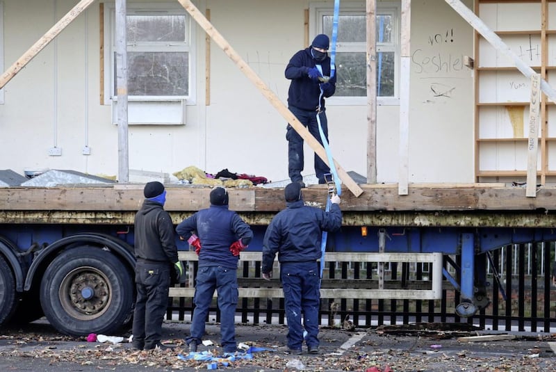 Masked contractors remove a portacabin from East Belfast FC&#39;s ground. Picture Mal McCann. 