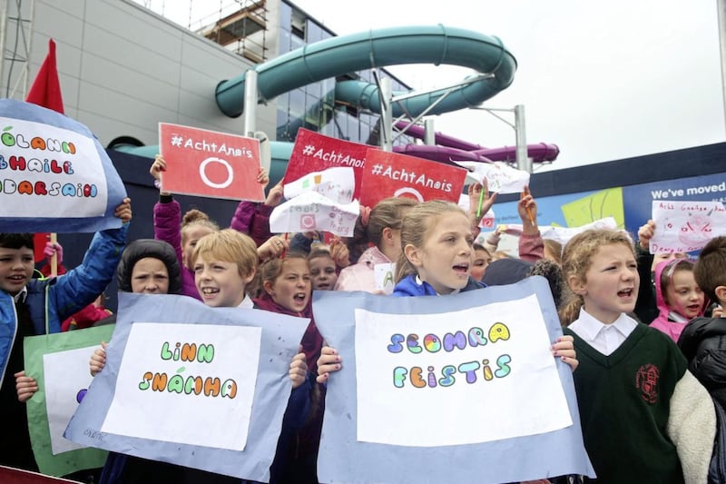 Pupils from Bunscoil Phobail Feirste protest outside the Andersonstown Leisure Centre site calling for bilingual signage in the centre when it opens next year Picture Mal McCann. 