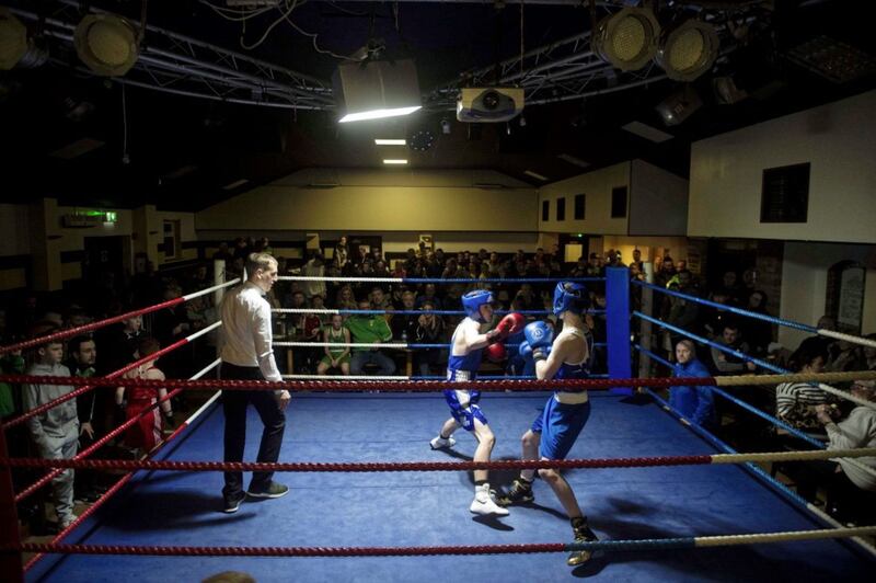 Referee Michael Hawkins jr looks on as Martin Doherty (left) of Holy Trinity and Clonard&rsquo;s Damien McGuigan entertain a packed out Trinity Lodge during a night of exhibition bouts. Picture by Mark Marlow 