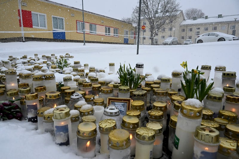 Candles and flowers left at the school (Jussi Nukari/Lehtikuva via AP)