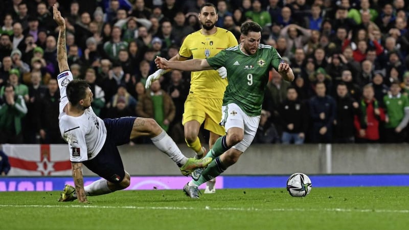 Northern Ireland&rsquo;s Conor Washington evades a lunging Italian defender. <br />Pic Colm Lenaghan/ Pacemaker