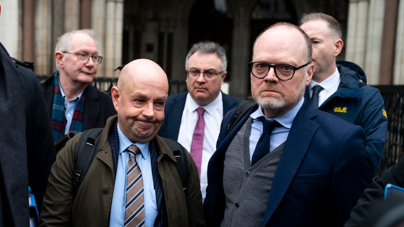 Journalists Barry McCaffrey (left) and Trevor Birney (right) outside the Royal Courts of Justice in London ahead of a specialist tribunal over claims UK authorities used unlawful covert surveillance. Both are wearing suits and ties.