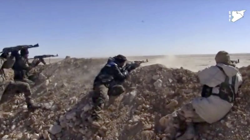 This frame grab from a video provided by the Syria Democratic Forces (SDF), shows fighters from the US-backed SDF opening fire on an Islamic State group's position, in Raqqa's eastern countryside in March, 2017