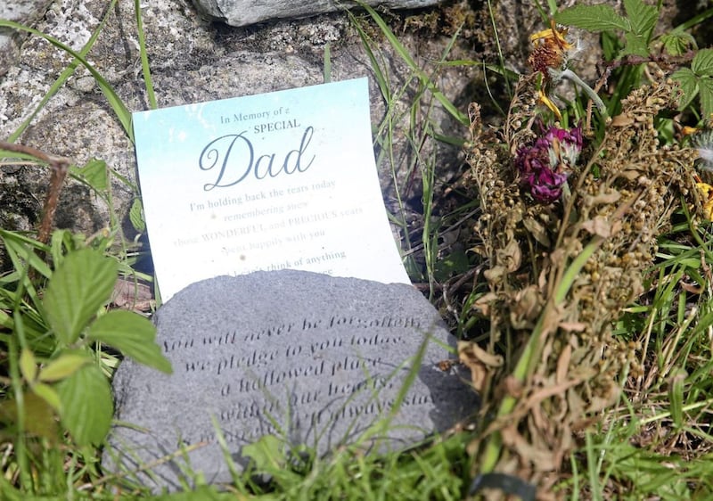 Flowers and a card to remember a lost parent at Bloody Bridge in the Mournes. Picture by Mal McCann 