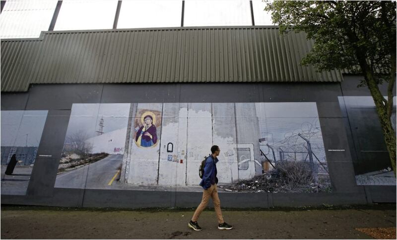 The WALLonWALL photographic exhibition was installed on one of Belfast&#39;s &#39;peace&#39; walls at Cupar Way last year. The exhibition, about walls that separate people worldwide in places including the Middle East, came to Belfast 50 years after the first &#39;peace line&#39; was erected in the city. Picture by Hugh Russell 