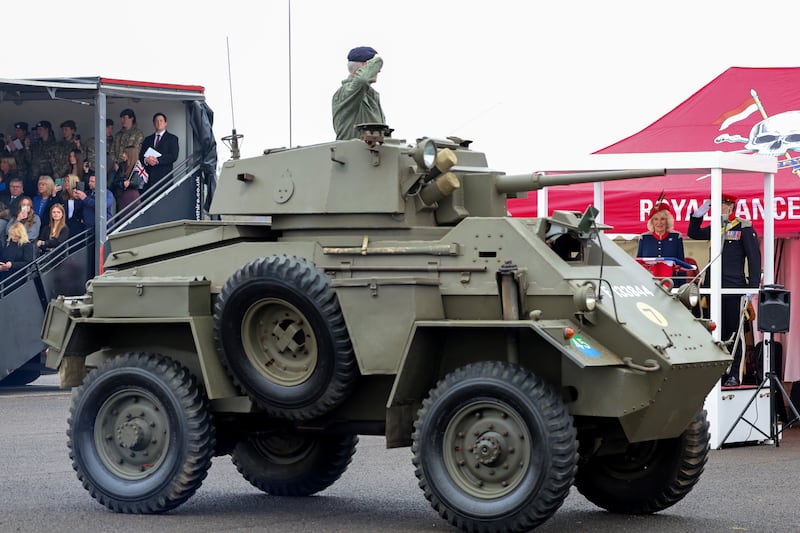 A Humber armoured vehicle from the Second World War parades past Queen Camilla during her to visit to The Royal Lancers regiment