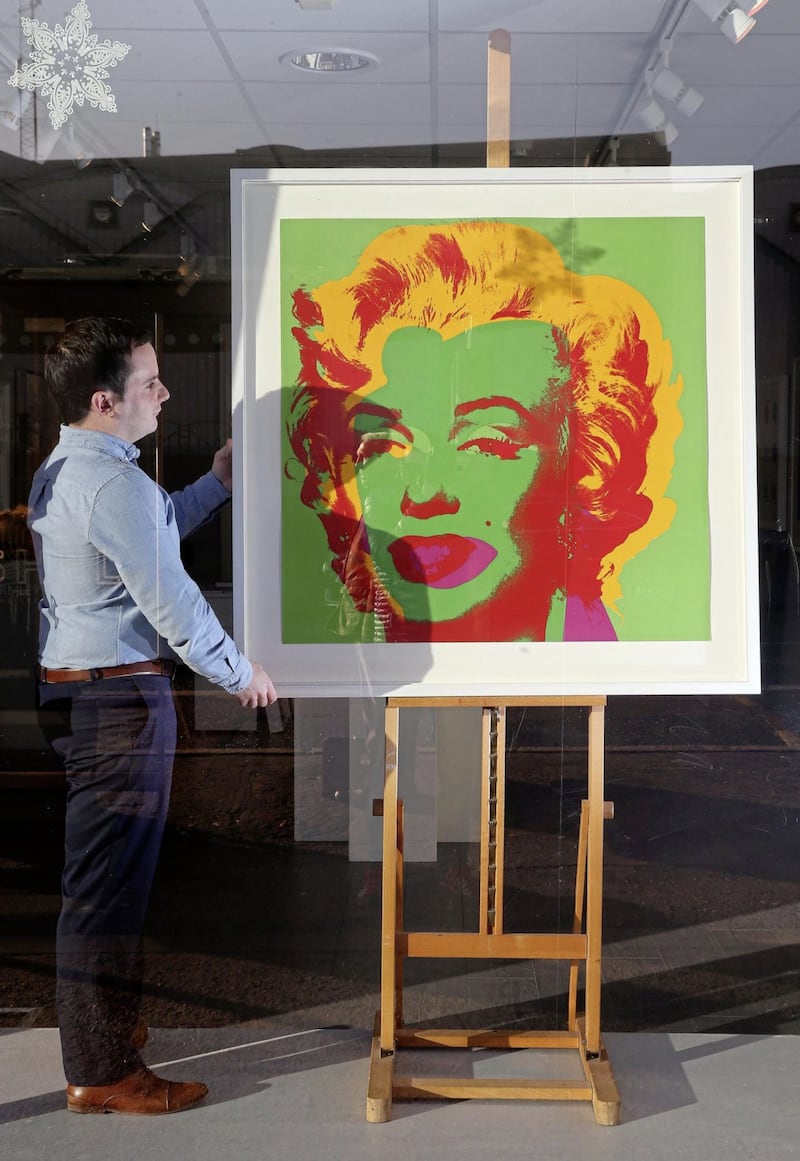 Gerard Gormley with the screen print of Marilyn Monroe by Andy Warhol for sale in the Lisburn Road Gallery. Picture by Mal McCann 