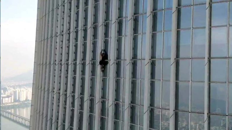 The man climbing Lotte World Tower, the tallest skyscraper in South Korea (The Seoul Metropolitan Fire and Disaster Management Headquarters, via AP).