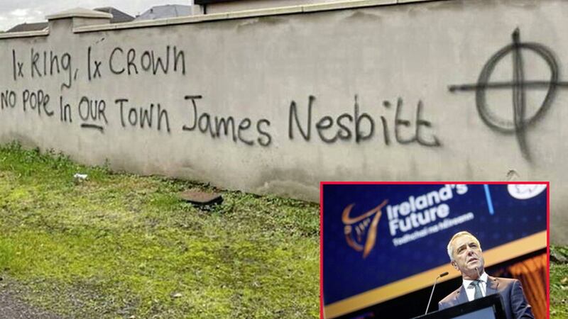 Graffiti targeting actor James Nesbitt has appeared in Portrush after he delivered the keynote address at the Ireland's Future rally at the 3Arena in Dublin last month (inset) 