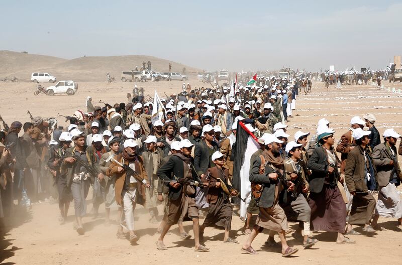 Houthi fighters march during a rally of support for the Palestinians in the Gaza Strip and against the US strikes on Yemen outside Sanaa on Monday (AP)