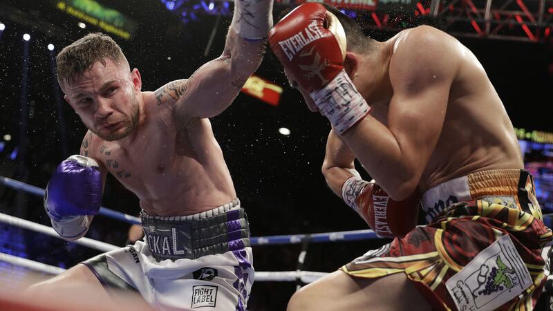 Carl Frampton, left, follows through on a punch to Leo Santa Cruz during their world featherweight title boxing match last night, Saturday January 28 2017, in Las Vegas.