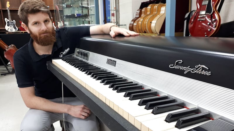 Auctioneer Luke Hobbs with the Fender Rhodes electric piano owned by former-10cc member Eric Stewart