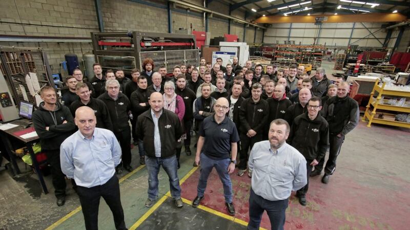KME Steelworks directors Seamus Murchan (front left) and Jason Quinn (front right) mark the end of a high growth year with staff at the Lisburn plant 