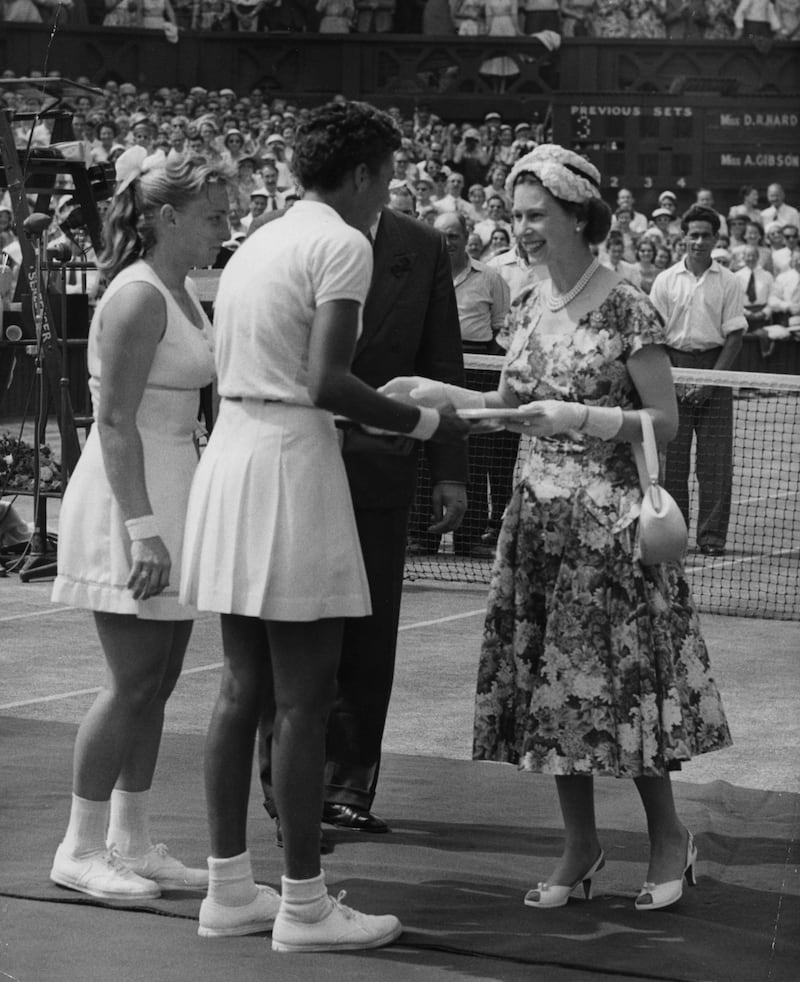 Queen Elizabeth II presenting American player Althea Gibson with the gold salver after she beat fellow American Darlene Hard in the Ladies Singles Final at Wimbledon 1957