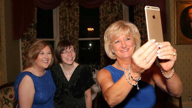 Tracy Hamilton of Mash Direct takes a photo with Roseann Kelly (left), chief executive Women In Business and Madame Justice Denise McBride QC at the Women In Business event at the Culloden Hotel in Belfast. Picture by Declan Roughan &nbsp;